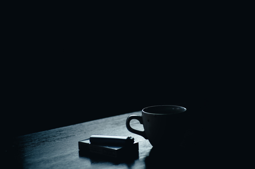 Coffee and cigarettes on table