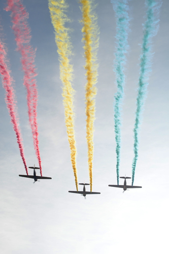 Three planes with colorful trail