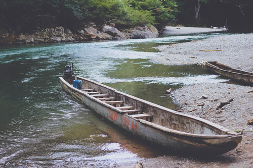 Old canoe on a river beach