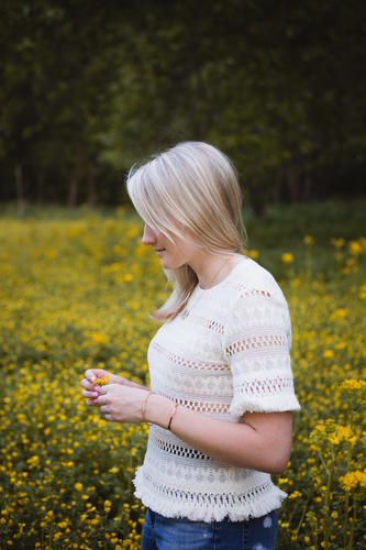 Blonde girl in flower field