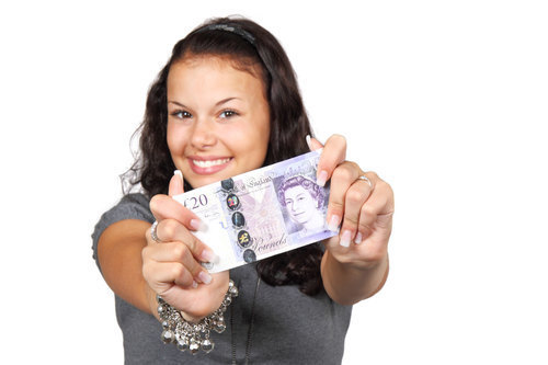 Cute girl showing a banknote