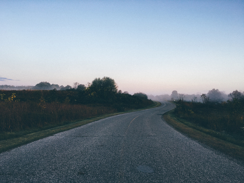 Road through misty landscape