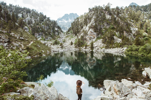 Woman photographing a lake