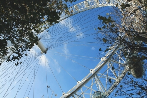 Observation wheel against blue sky