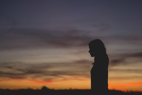Woman silhouette in sunset