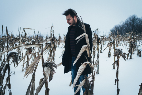 Man in snow cowered cornfield