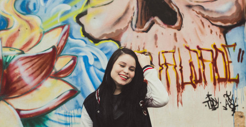 Girl in front of the graffiti