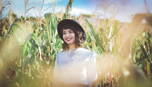 Щаслива дівчина в поле кукурудзи