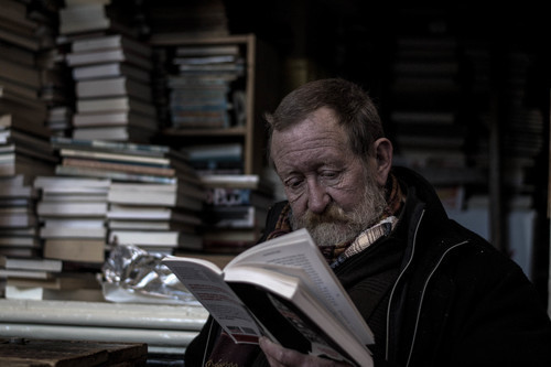 Old man reading a book