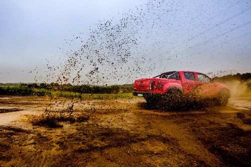 Car driving through mud