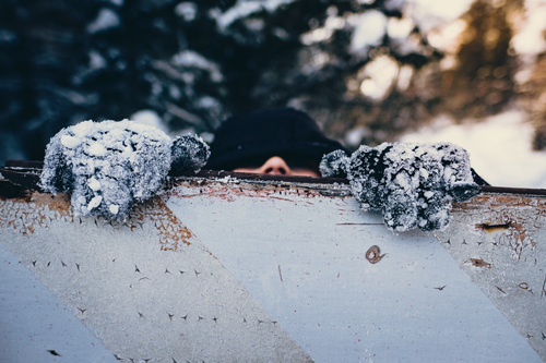 Man peeking over an object