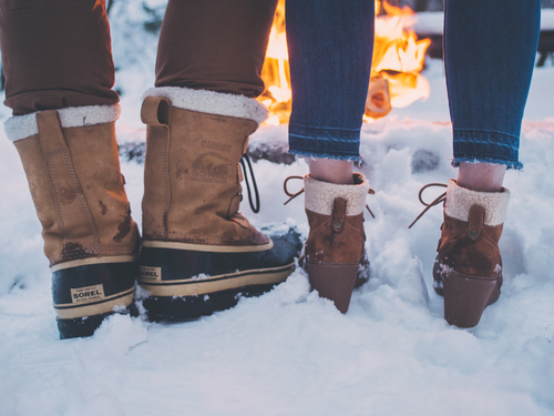 Male and female shoes in snow