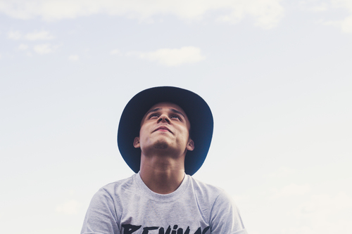 Guy with hat looking at the sky