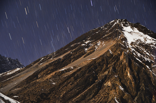 Snowy mountain with falling stars