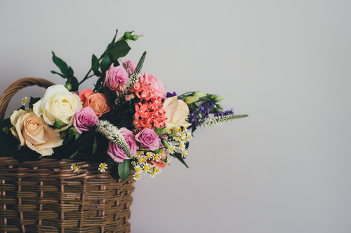 Roses and other flowers in basket