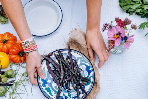 Purple beans on colorful plate and table