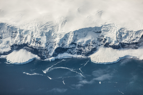 Cold sea touching snow-covered shore