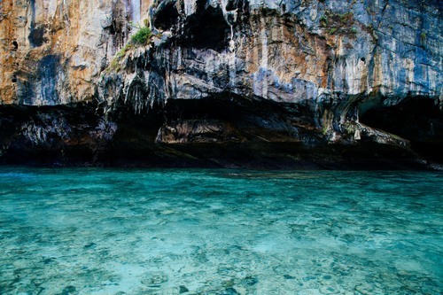 Clear water under cliff