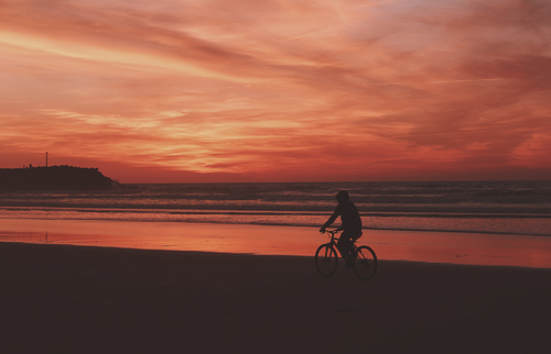 Andar de bicicleta ao longo da praia