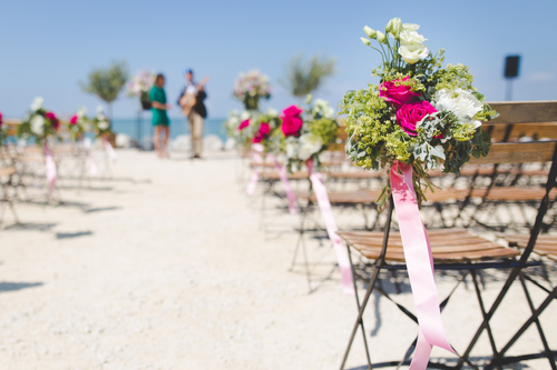 Decorated chairs by the sea.