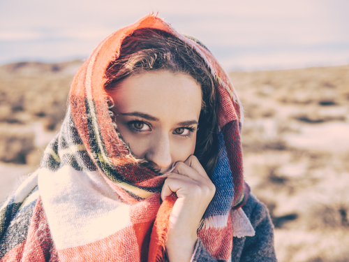 Smiling girl covered with scarf