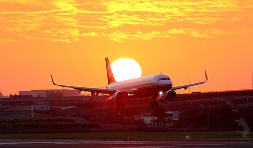 Vliegtuig landing bij zonsondergang