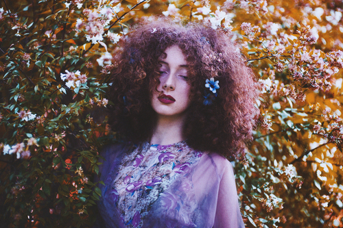 Curly girl in flowers
