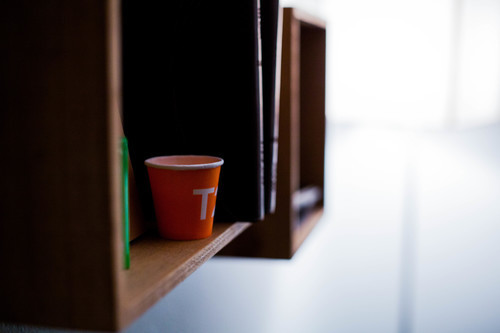 Coffee cup on book shelf