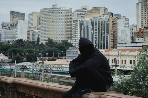 Hooded man on wall