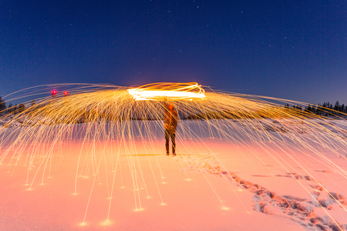 Man in snow with firecrackers