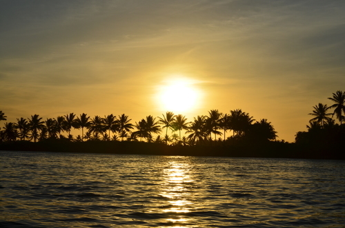 Tropiska kusten med solnedgång