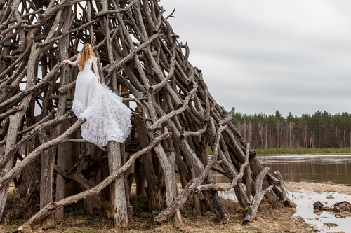 Bride climbs wood structure