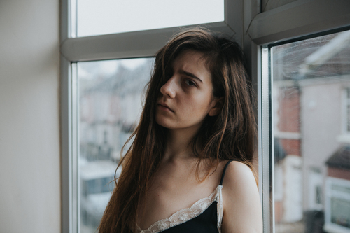 Sad female by the window