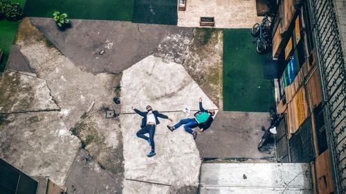 Two guys laying on the floor