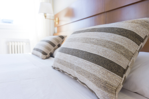 Stripy pillows on bed