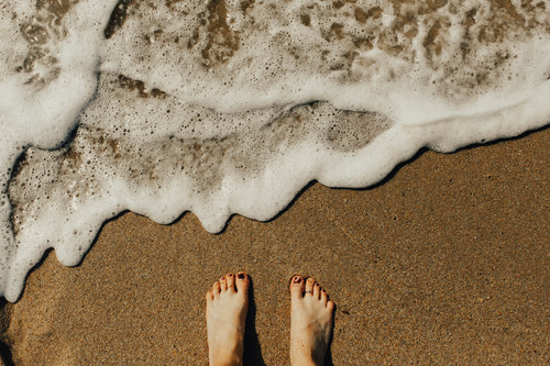 Feet on beach sand