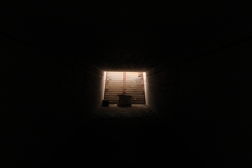Stairs in dark tunnel