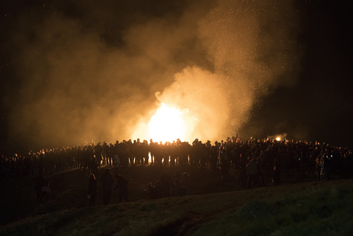People gathered around big fire