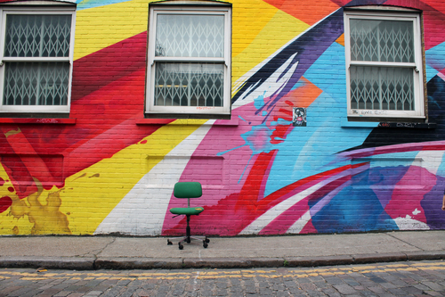 Chair in front of graffiti
