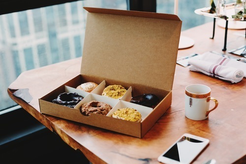 Box of donuts and cup of coffee