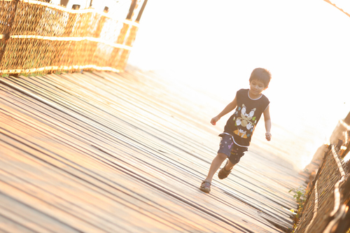 Child running across bridge