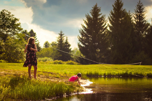 Children fishing in pond