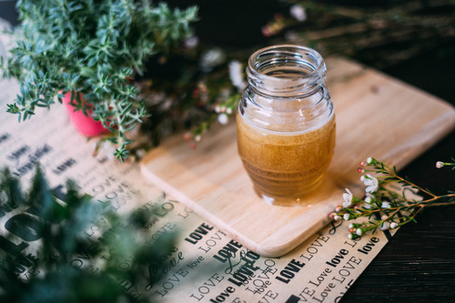 Honey jar with green plants