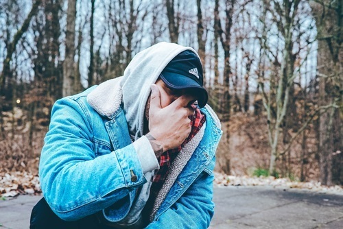Man covering his face with hand
