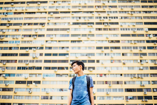 Japanese boy in front of yellow building