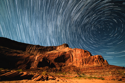 Star trails covering cliff