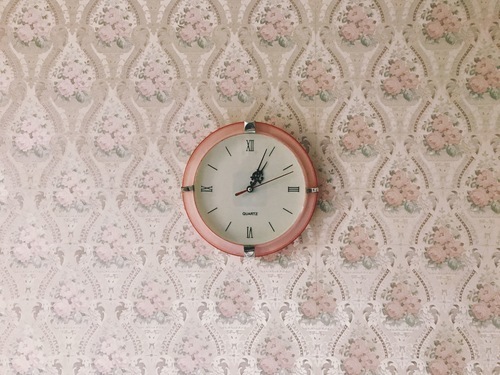 Clock on a floral wallpaper
