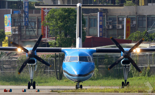 Blått flygplan på en start