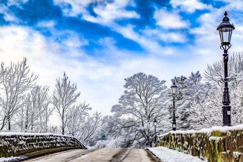 Winter landscape with a road and a street lamp