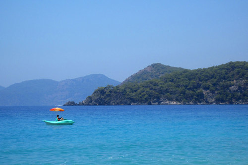 Blue pedal boat with the parasol